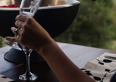 pouring a glass of champagne - Valhalla Glamping packages can include bottle of bubbles