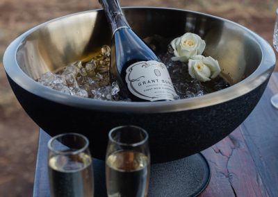 wine bowl with ice, wine and glasses outside luxury tent / Glamping secluded deck